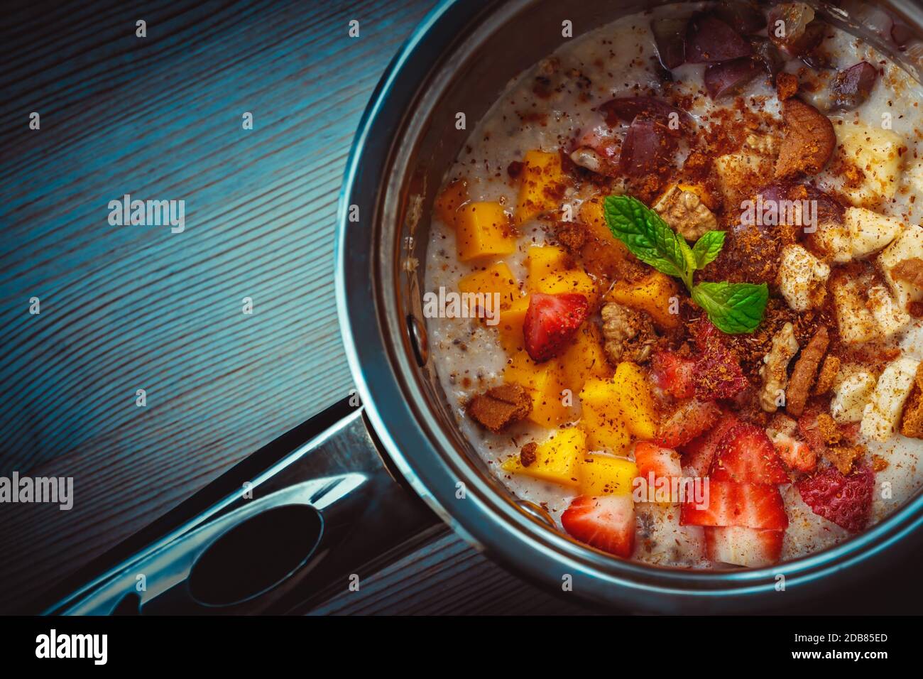 Tasty oatmeal prepared with fruits and nuts, healthy organic nutrition, tasty vegetarian food, superfood, detox and diet, local seasonal ingredients, Stock Photo