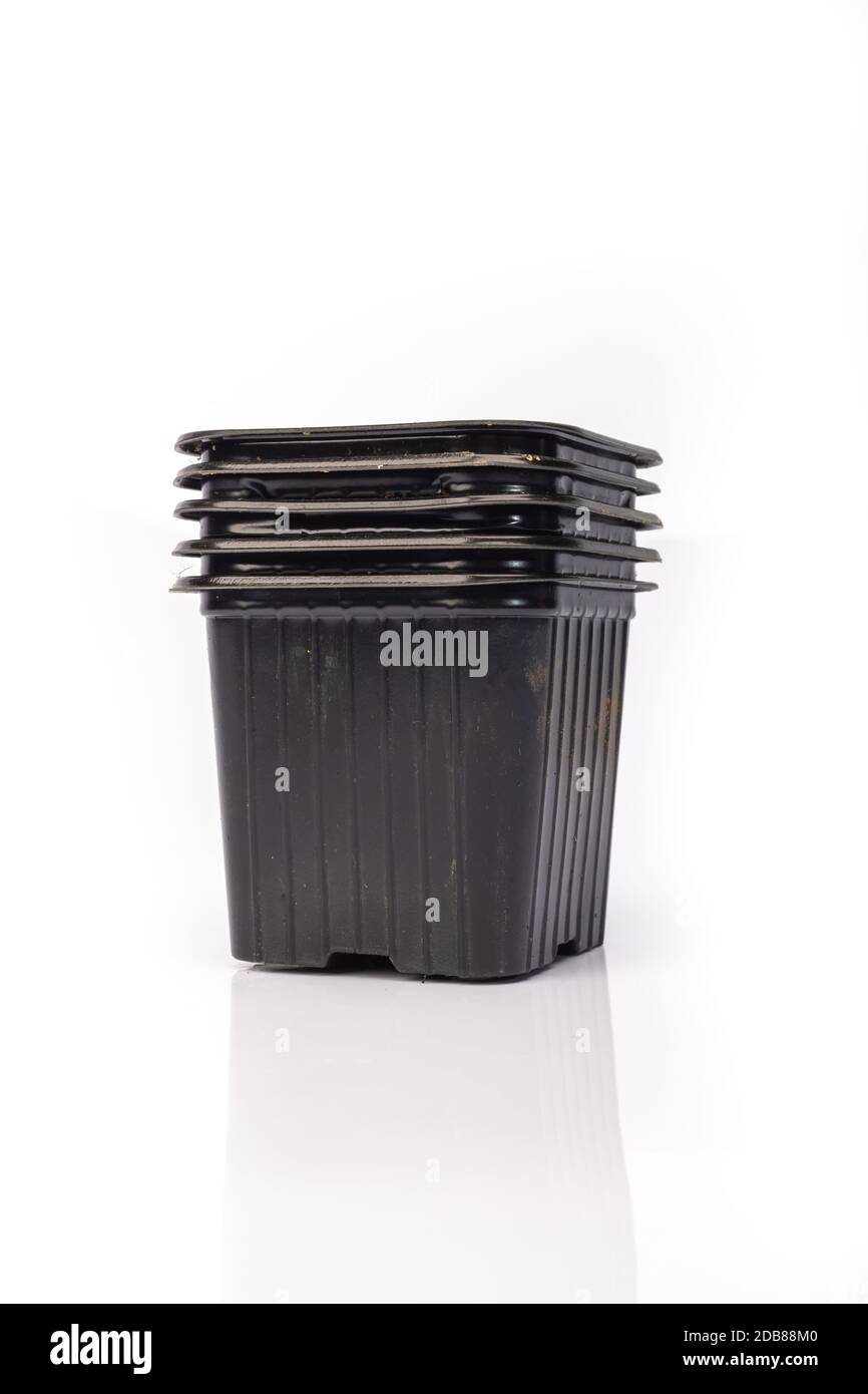 used black plastic gardening bucket waiting for spring on white