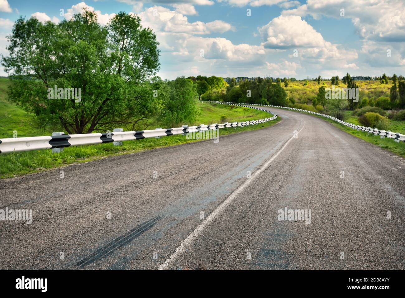 Asphalt road in the field by day Stock Photo - Alamy