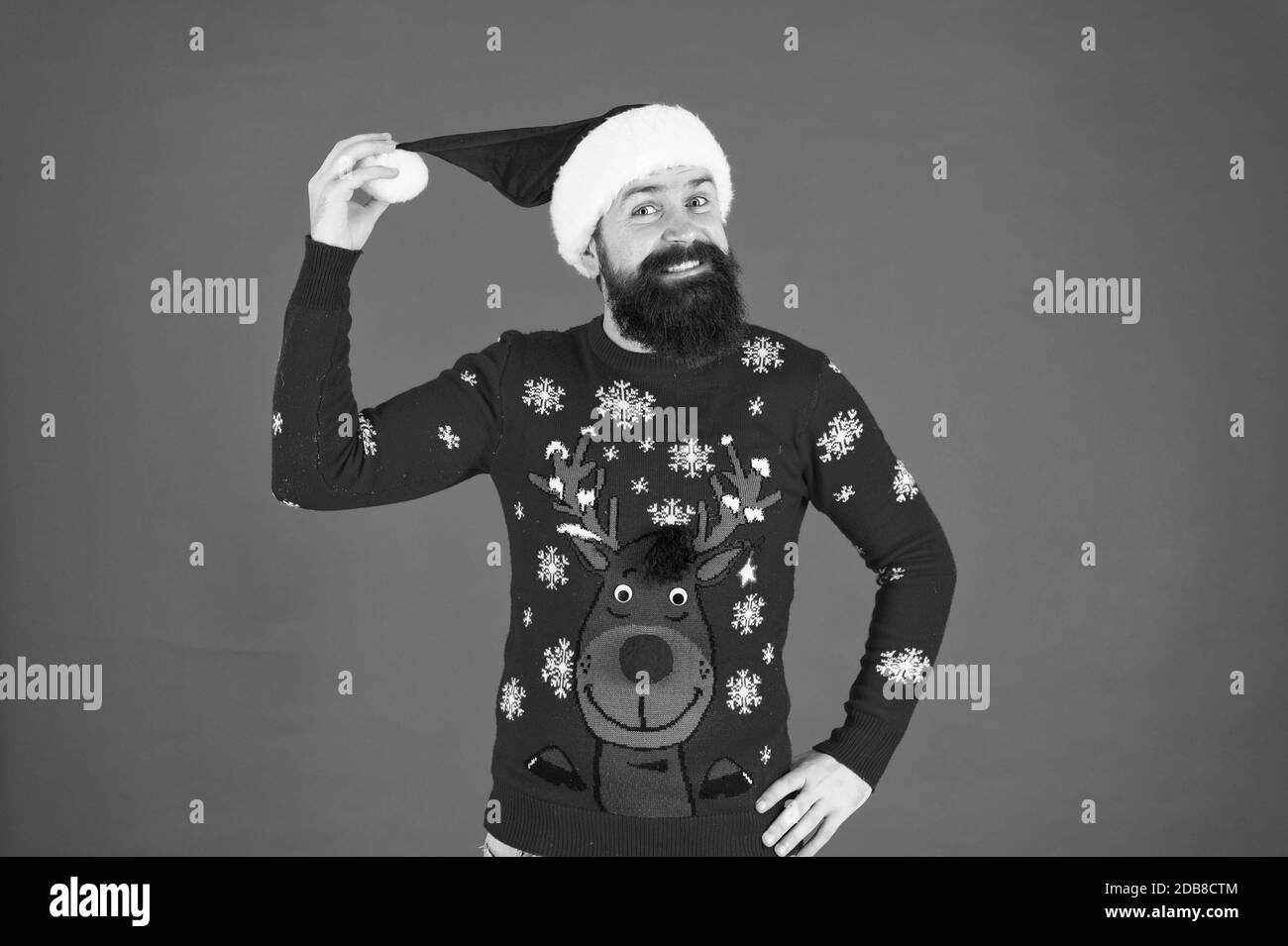 Join holiday celebration. Winter party outfit. Sweater with deer. Hipster bearded man wear winter clothes red background. Christmas celebration ideas. Start this party. Happy new year celebration. Stock Photo