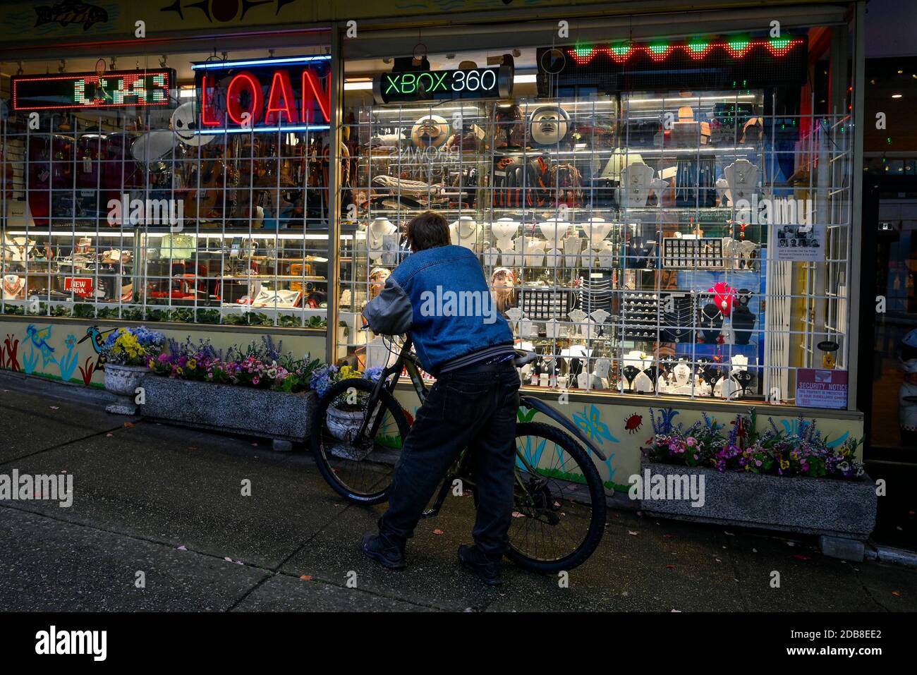 Man looking in window of Pawn Shop Stock Photo - Alamy