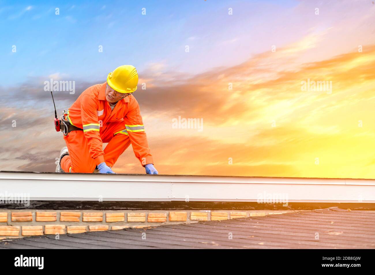 Construction worker working on a roof, Thailand Stock Photo