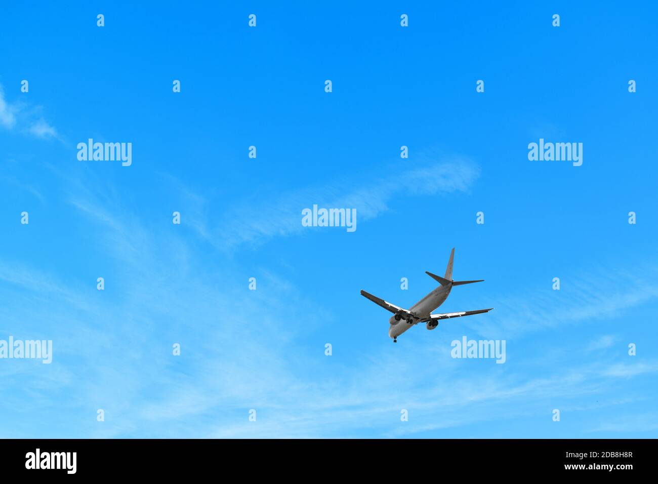Landing plane Blue Sky Background Stock Photo - Alamy