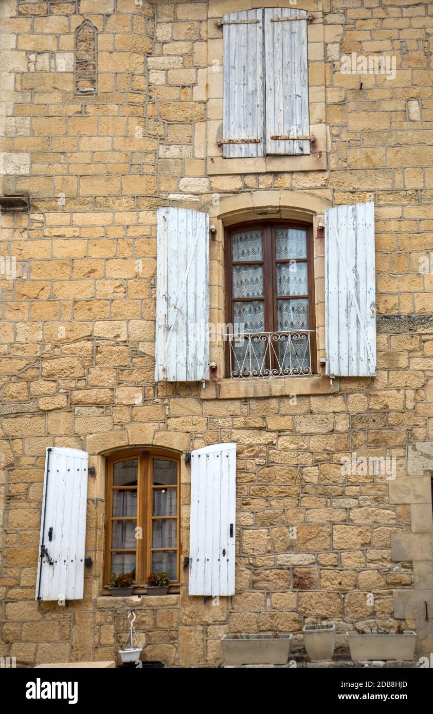 Old stone house with wooden shutters in Domme. Perigord, France Stock ...
