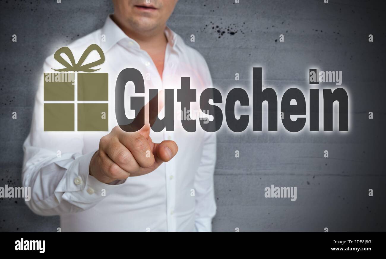 Gutschein (in german Voucher) is shown by man concept Stock Photo - Alamy