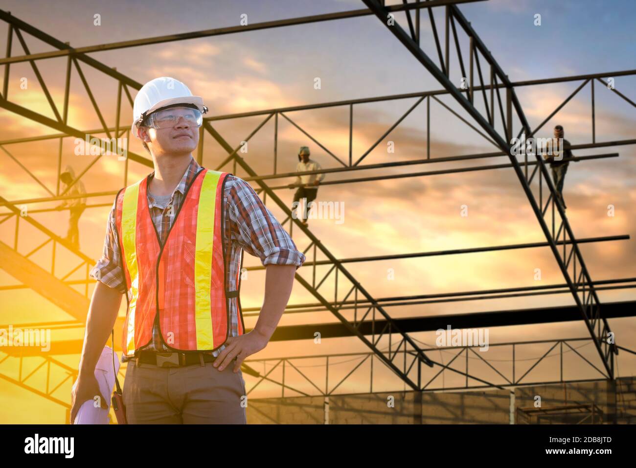 Construction worker standing in front of construction site, Thailand Stock Photo