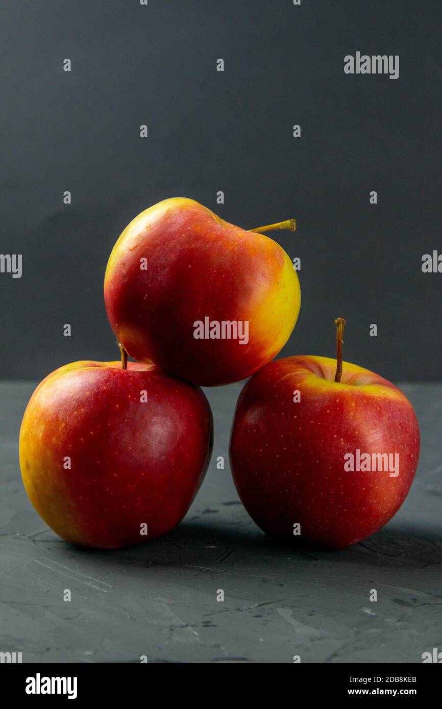 Apples on black stone table background. Front views Stock Photo