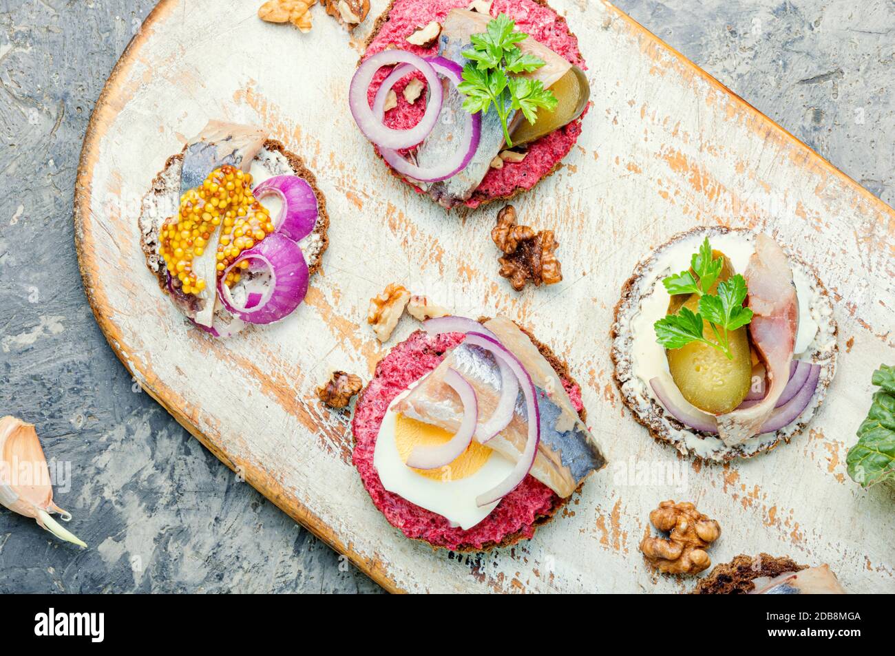 Small sandwiches or bruschettas with salted herring and beetroot.Open sandwich with salted herring Stock Photo