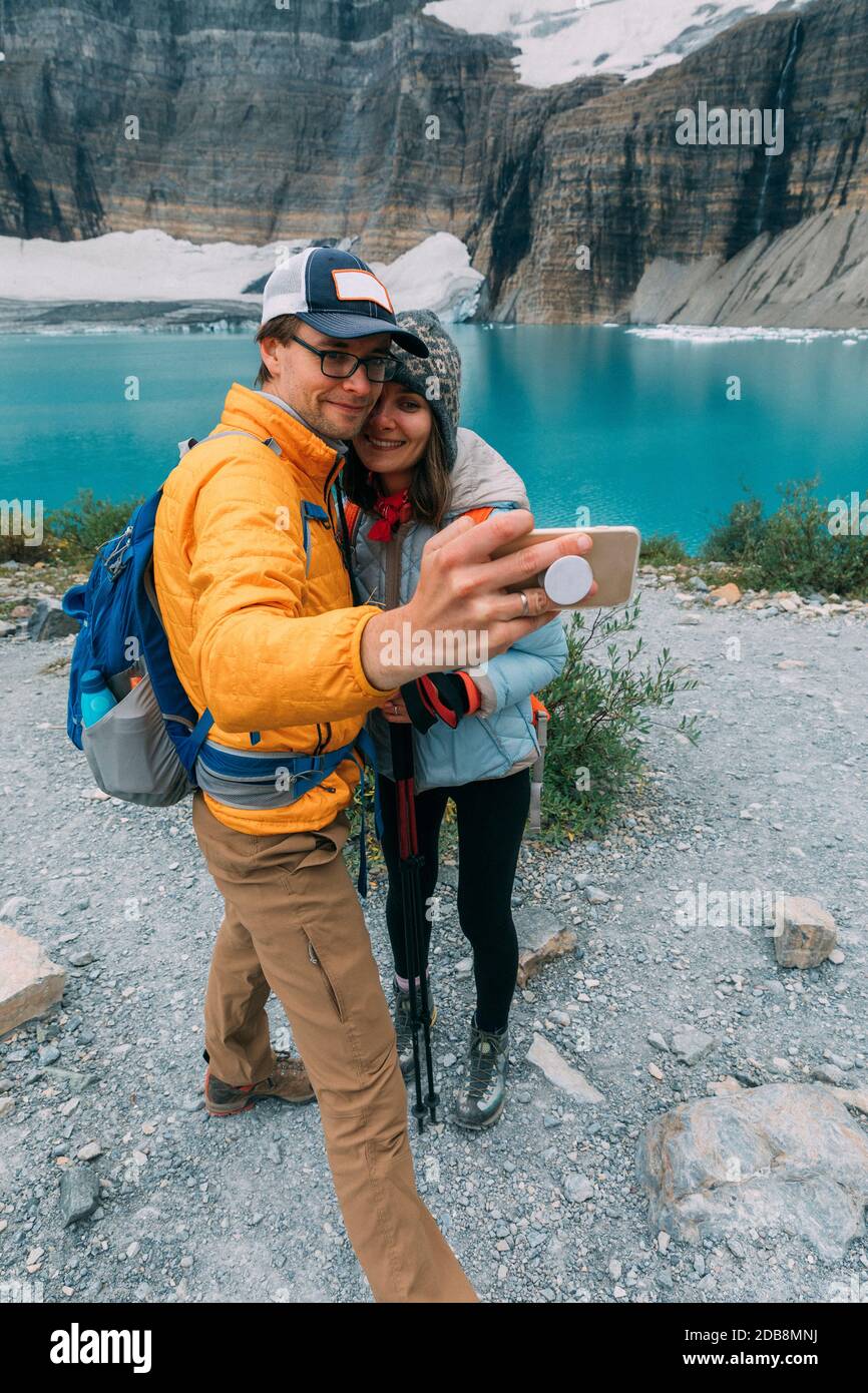 A couple taking a selfie in the Glacier National Park. Montana Stock Photo