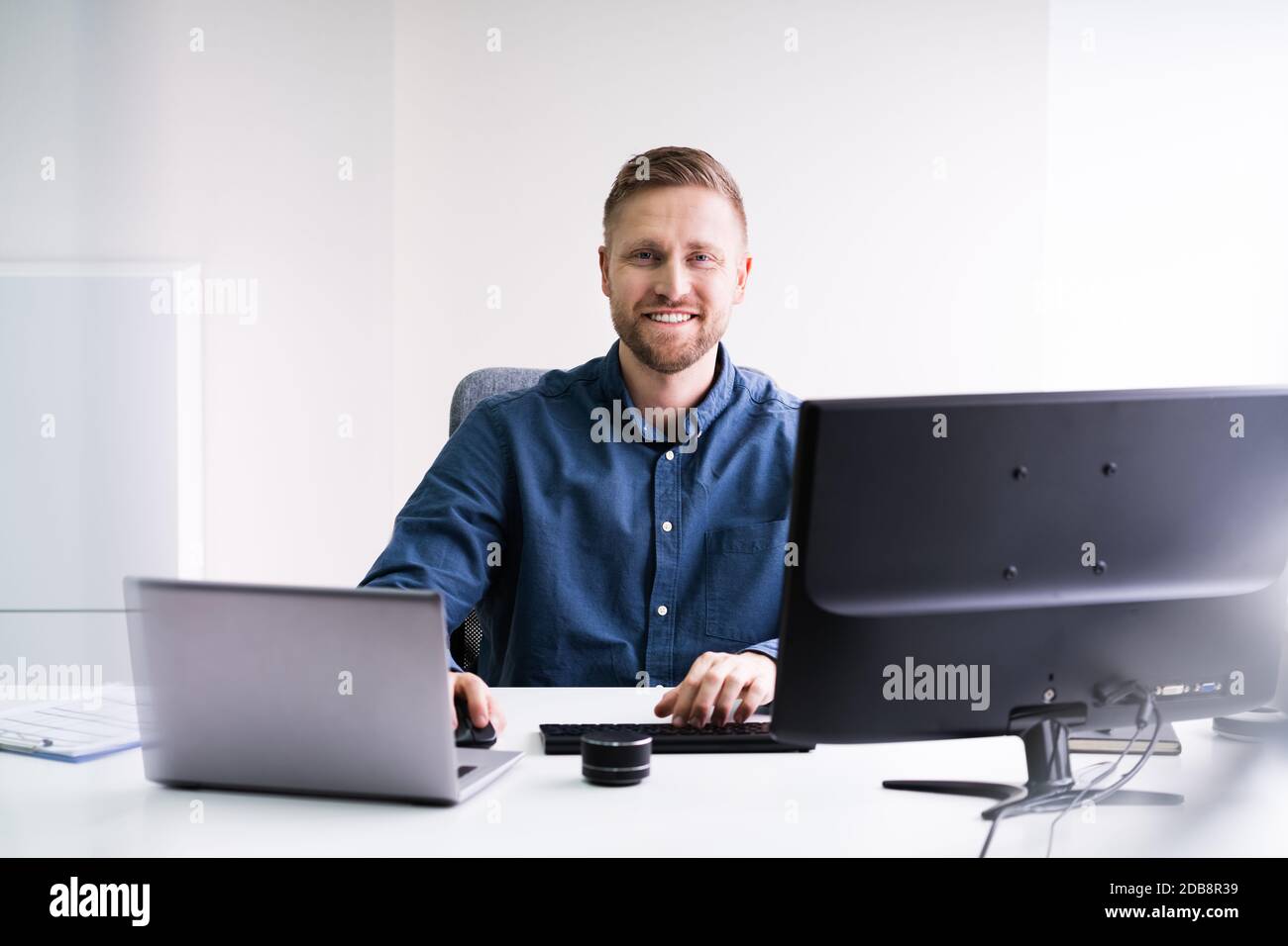 Man Working On Laptop Computer Doing Business Stock Photo