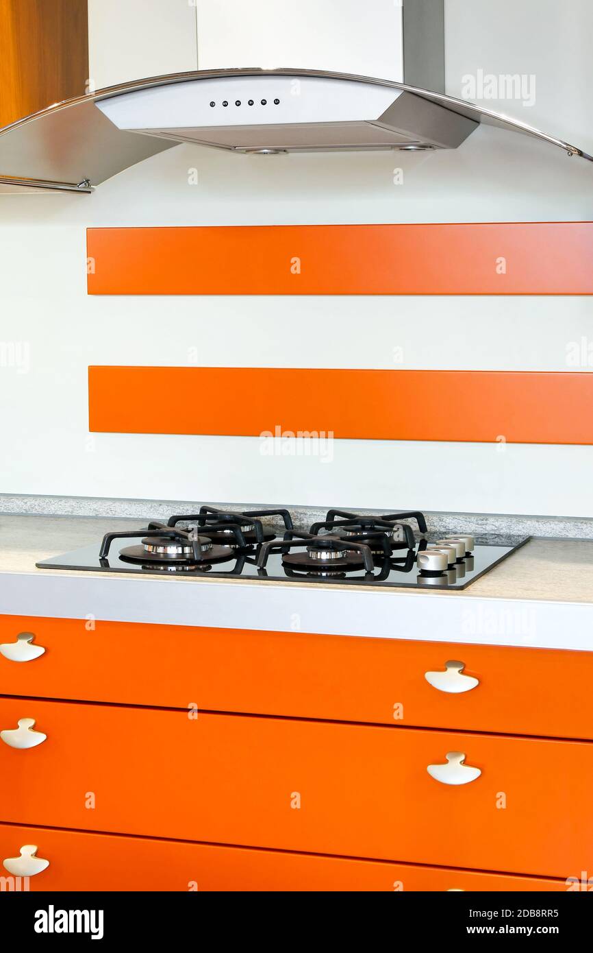 Orange style kitchen with gas burners stove Stock Photo Alamy