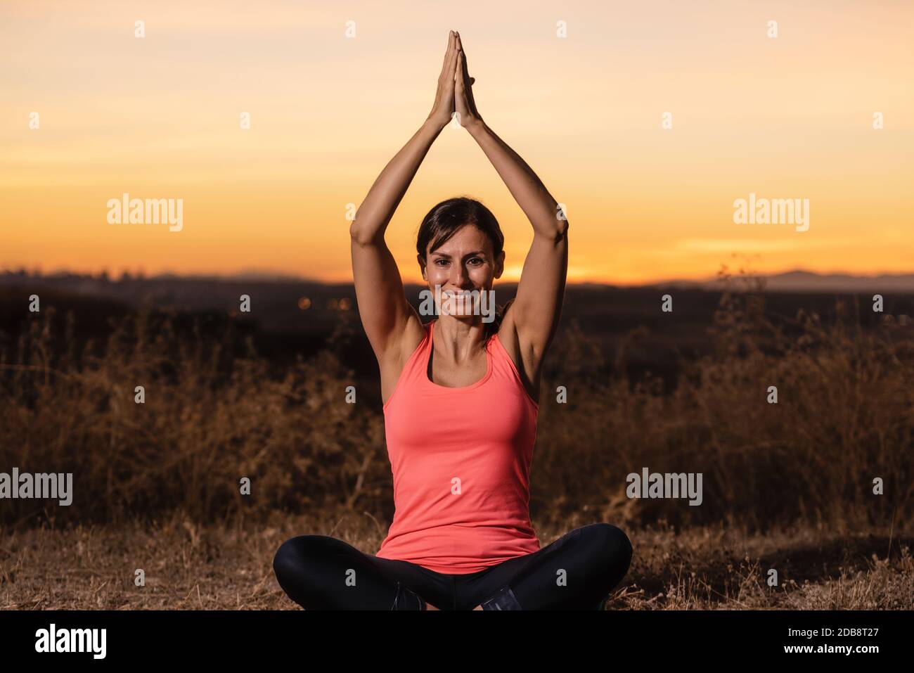 Woman doing yoga outdoors, enjoying good weather and positive energy in ...