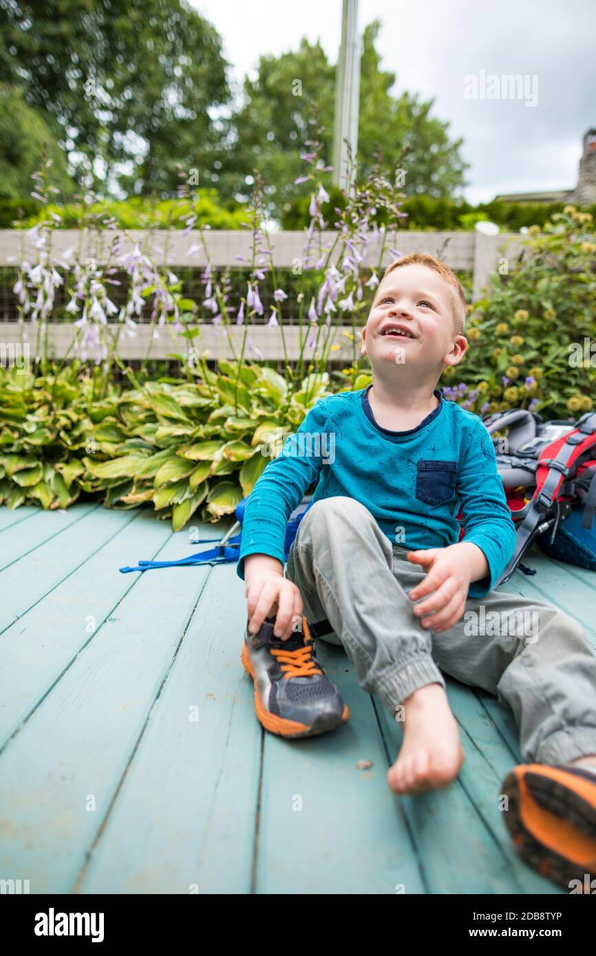 Toddler puts his own shoes on Stock Photo Alamy