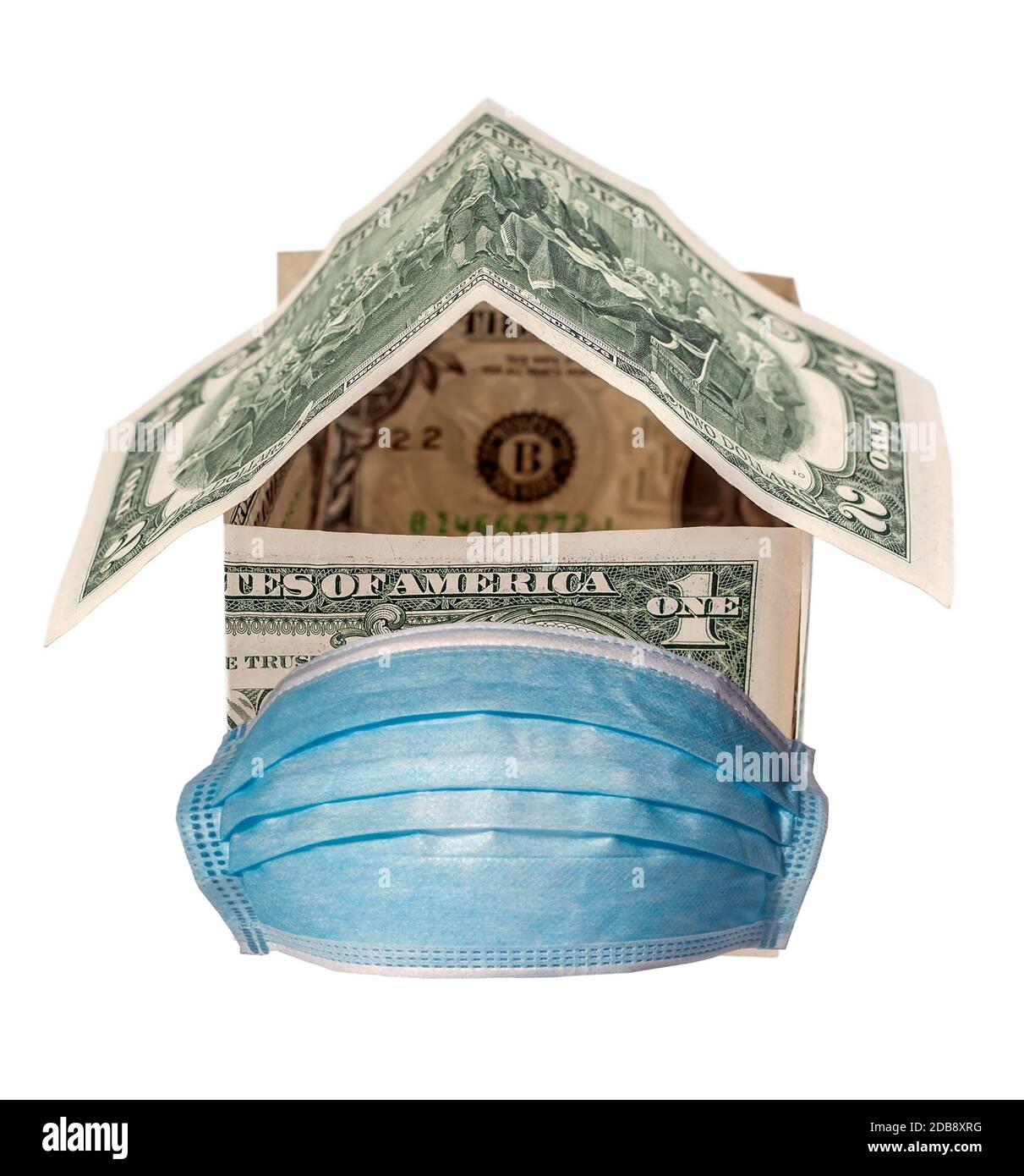 House made from United States dollar bill quarantine in Medical mask epidemic covid 19 protection infection. Hospital or pollution protect face maskin Stock Photo