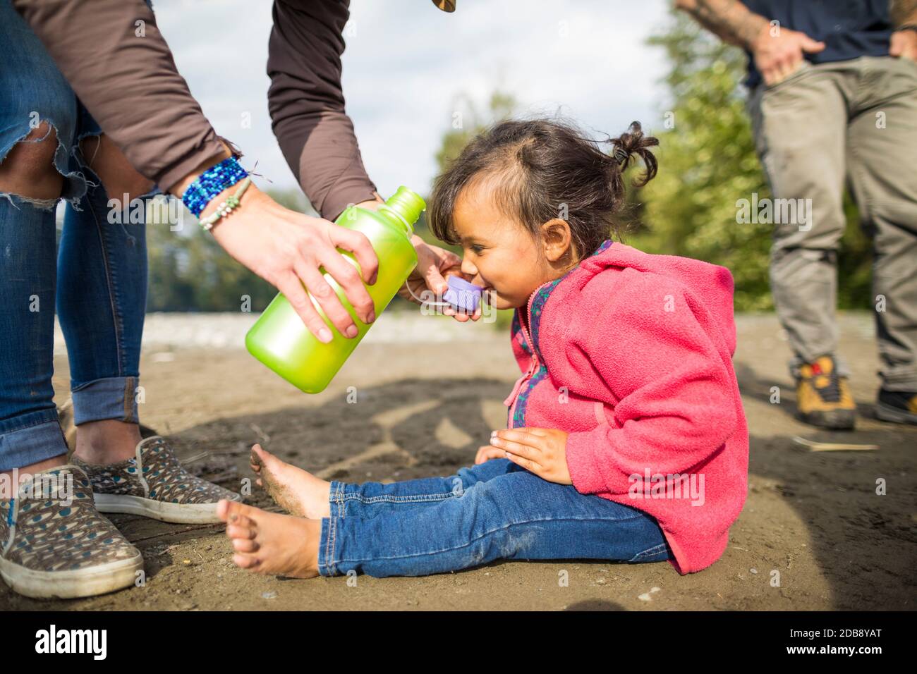 Toddler drinks from the lid of a canteen Stock Photo Alamy