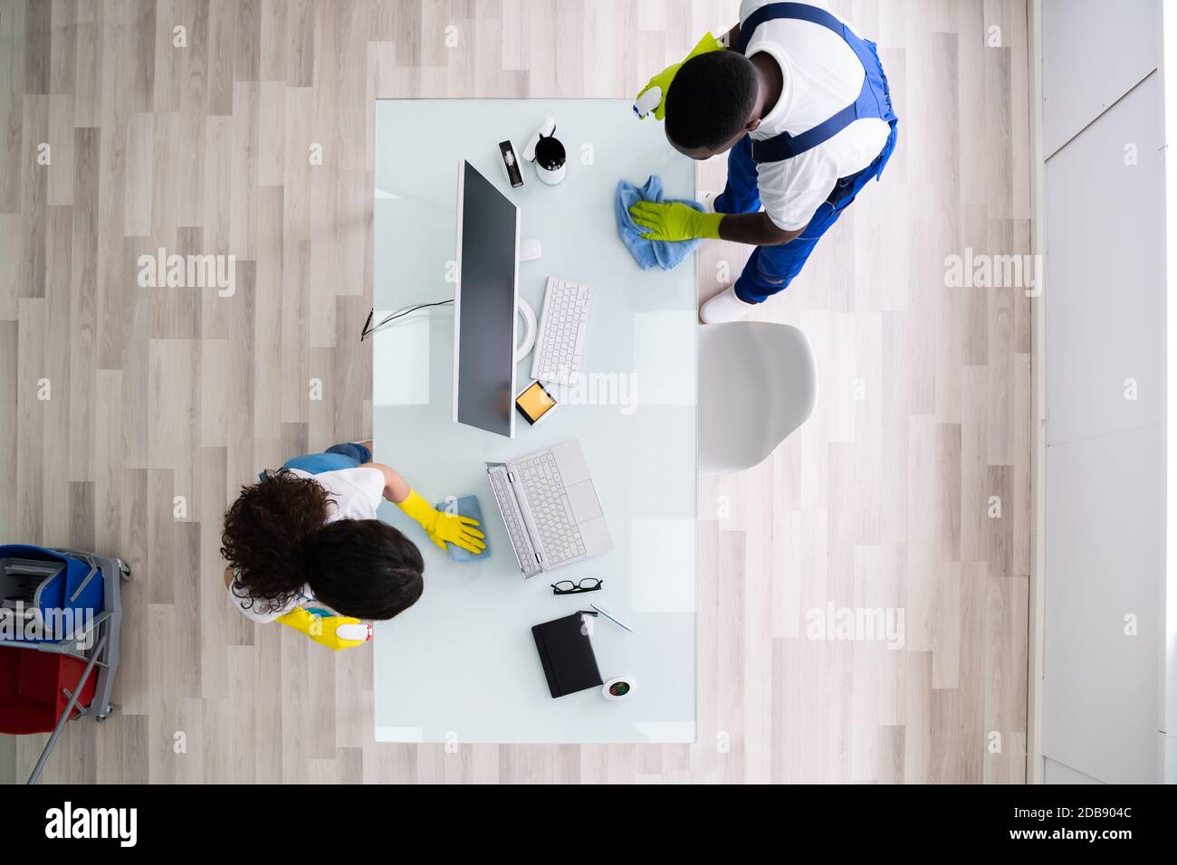 Cleaners Cleaning Computer Office Desk. High Angle View Stock Photo