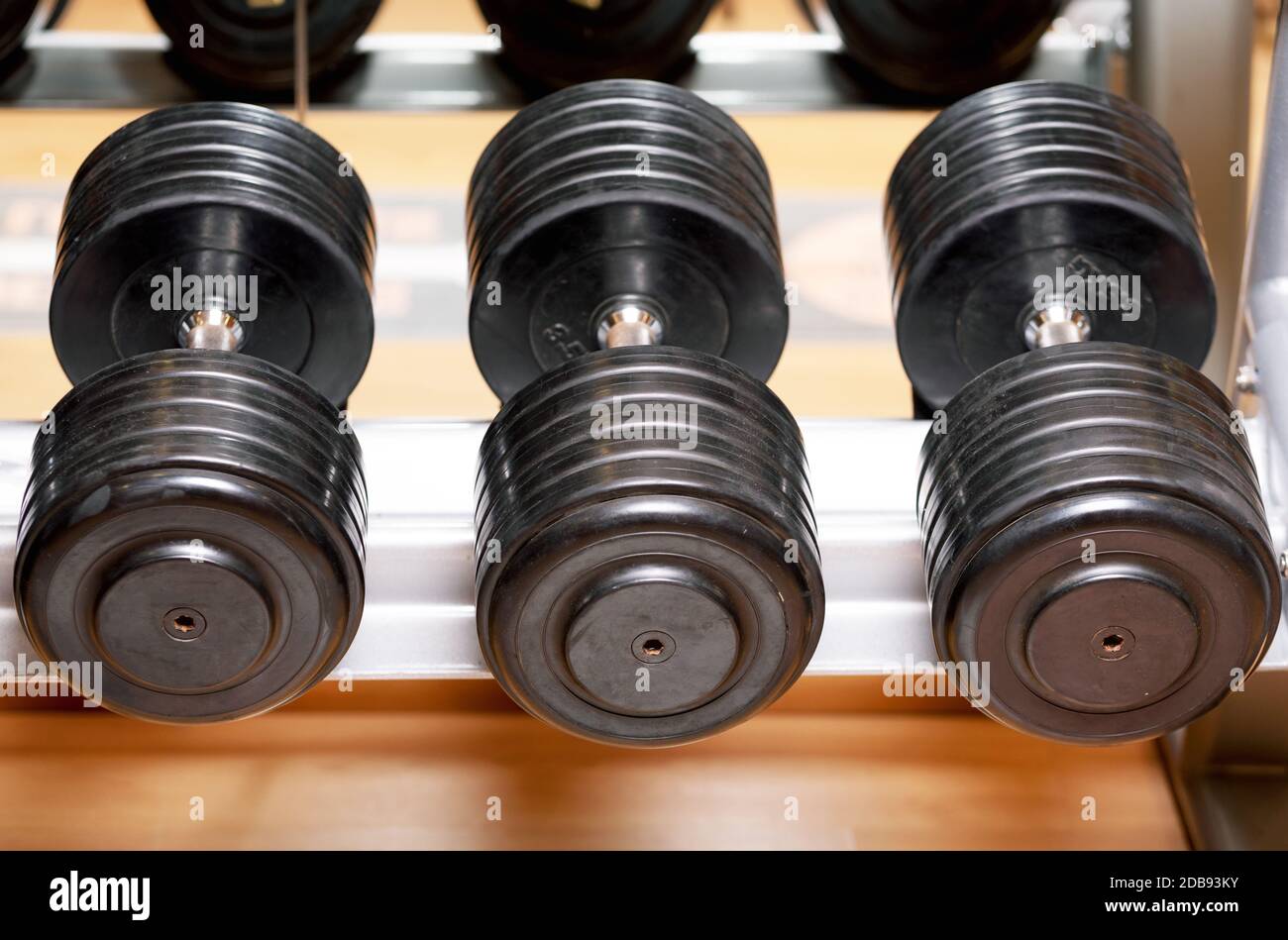 Different sizes and weights of dumbbell free weights at a gym Stock