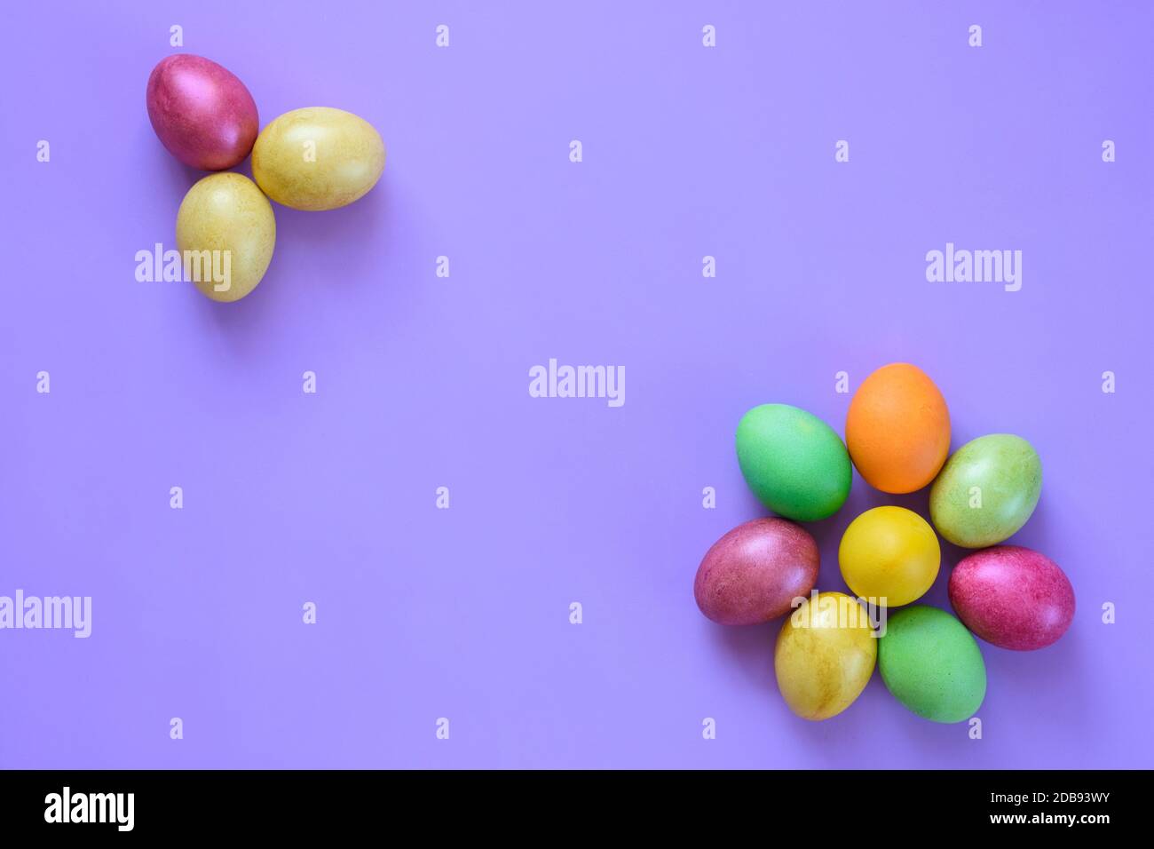 Easter beautiful eggs in the shape of flowers on a purple background ...