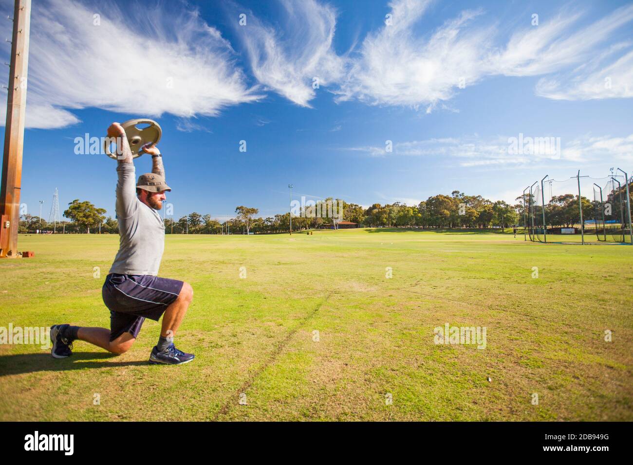 Man doing lunges with weights Stock Photo