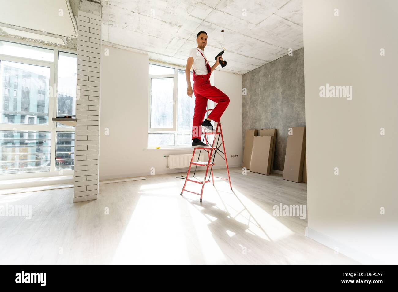 Electrician working with wires in new apartment Stock Photo Alamy
