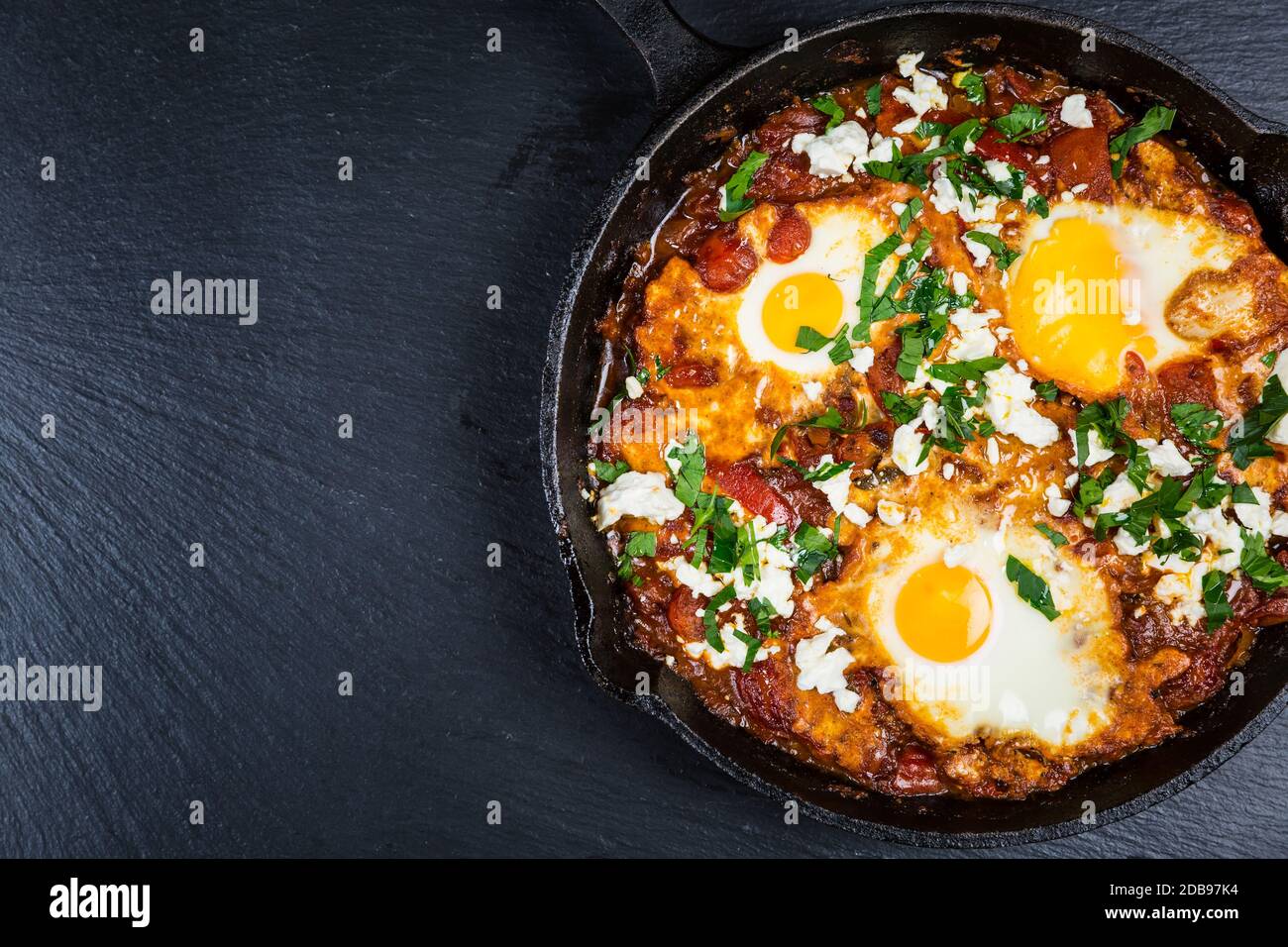Shakshouka Middle eastern traditional dish with poached eggs in