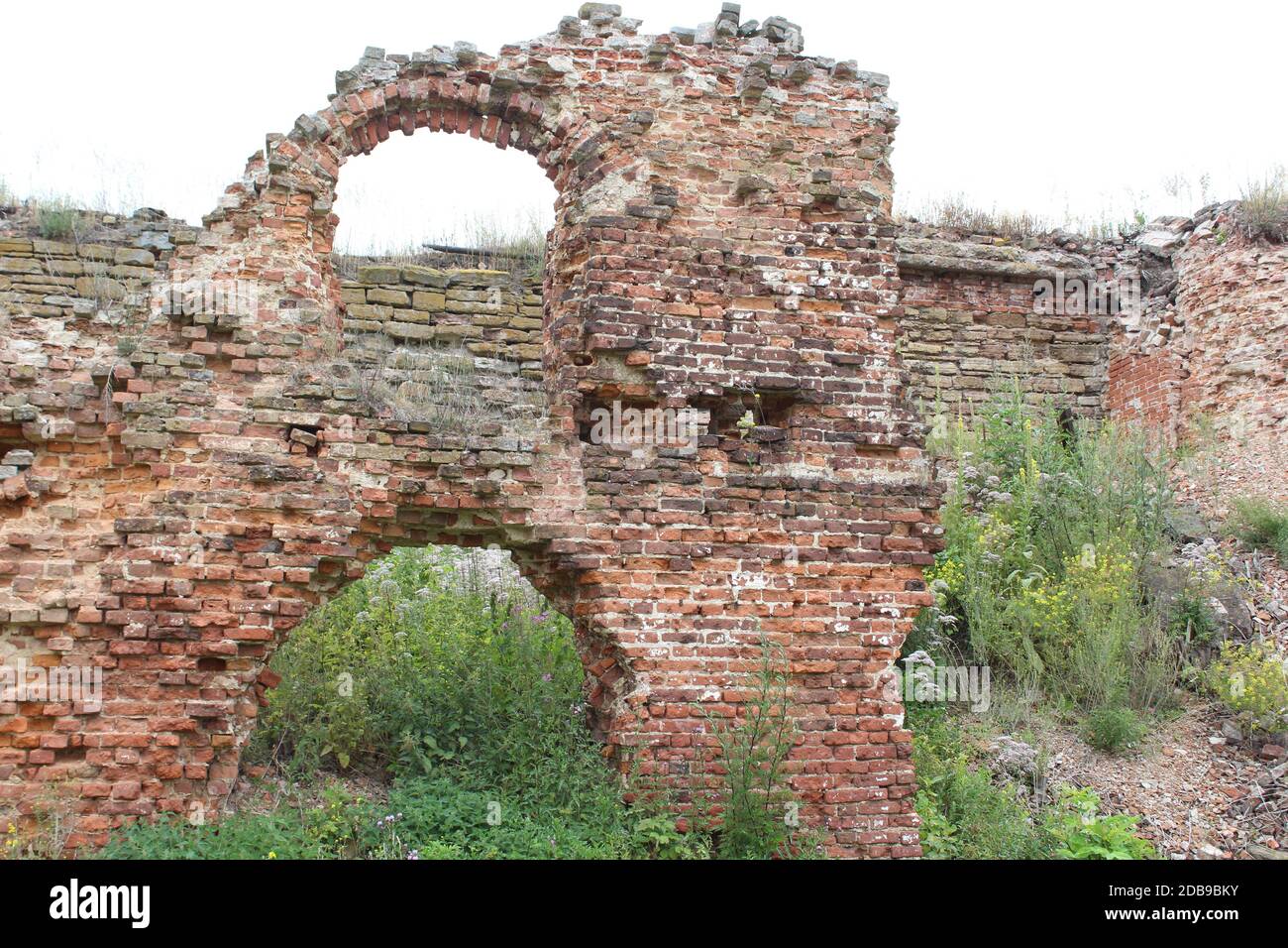 Detailed close up view on an aged and weathered red brick wall texture ...