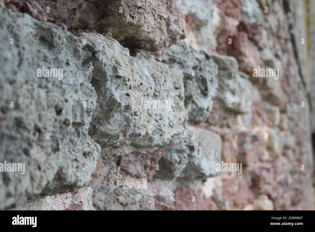 Detailed close up view on an aged and weathered red brick wall texture ...