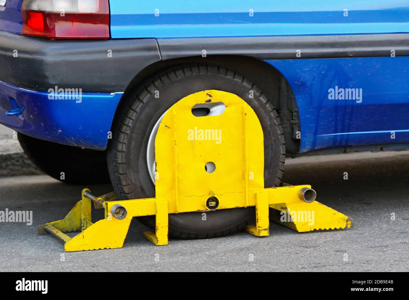Wrong parked vehicle with yellow wheel clamp Stock Photo