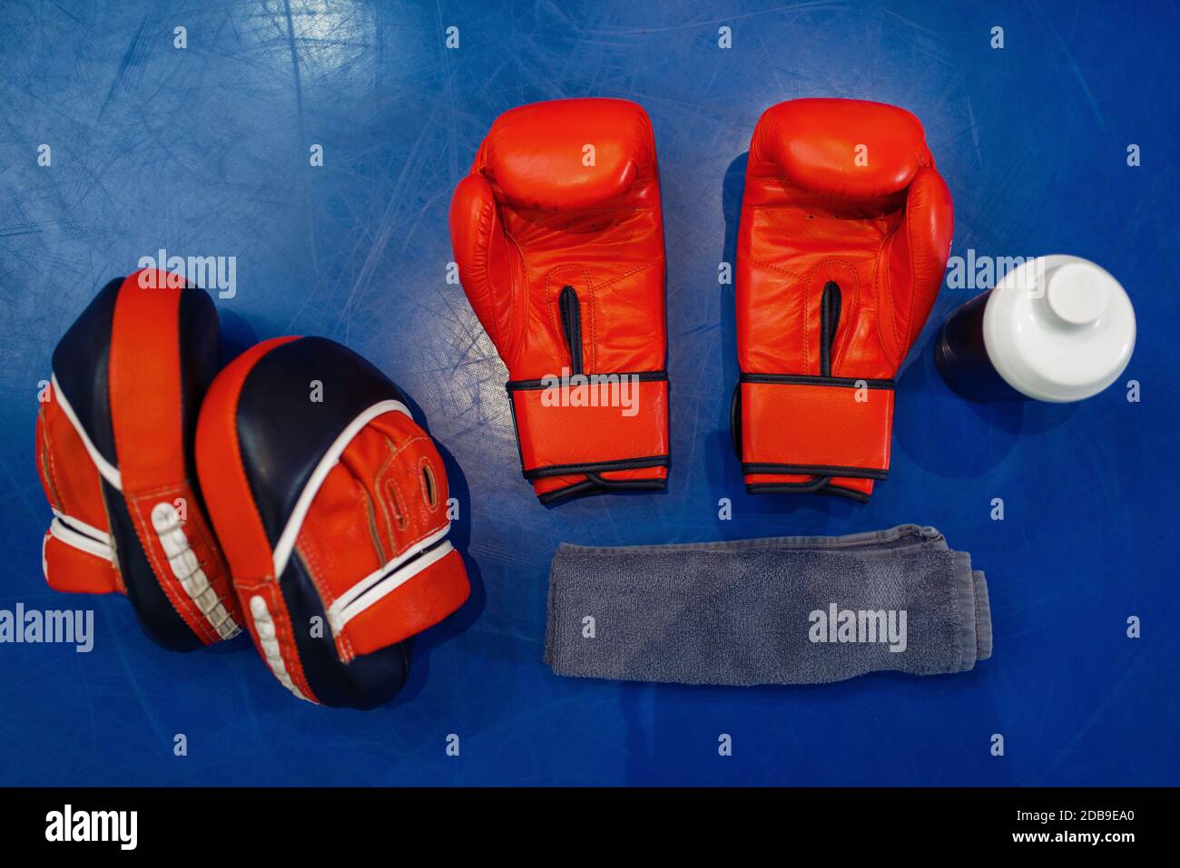 Pair of red boxing gloves, workout pads and equipment on ring canvas, top  view, nobody. Box or kickboxing sport concept, training tools, fighting  mart Stock Photo - Alamy
