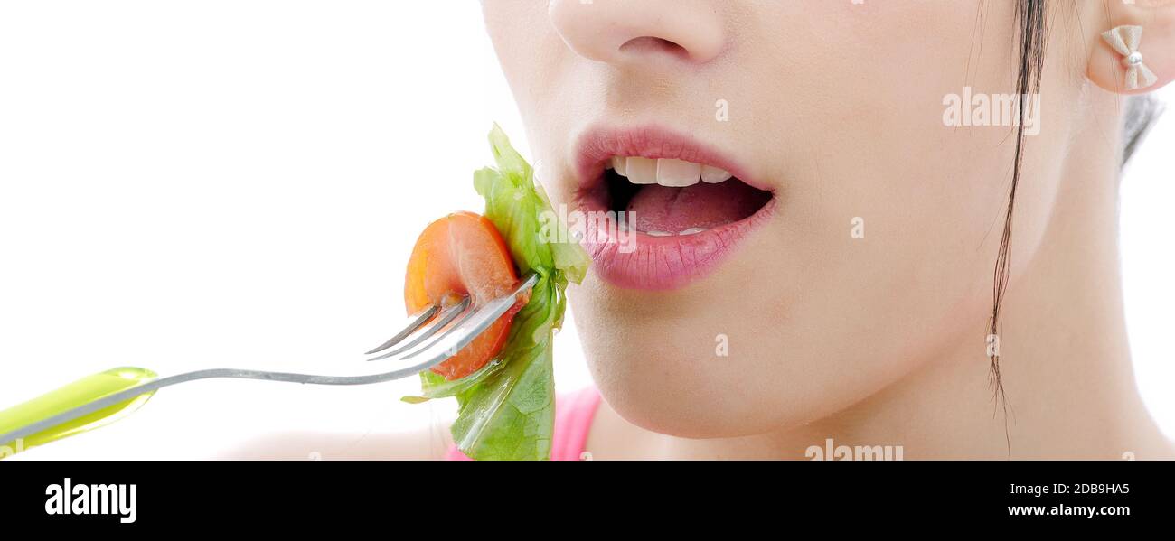 pretty young brunette woman eats salad, close up Stock Photo