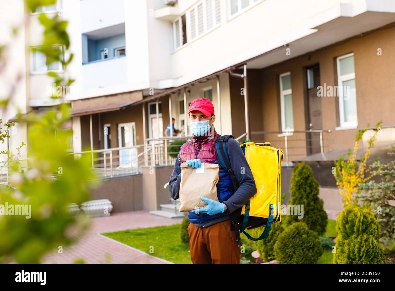 delivery man send food bag for contactless or contact free from ...