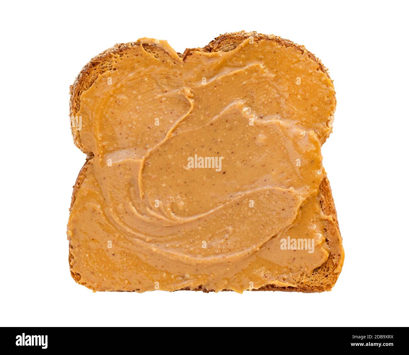 Creamy peanut butter spread on healthy whole wheat toast bread, isolated on white background, photographed from above Stock Photo