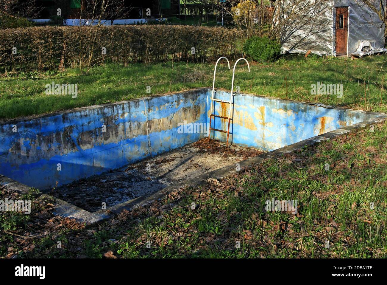 Abandoned swimming pool in bad rusty condition Stock Photo - Alamy