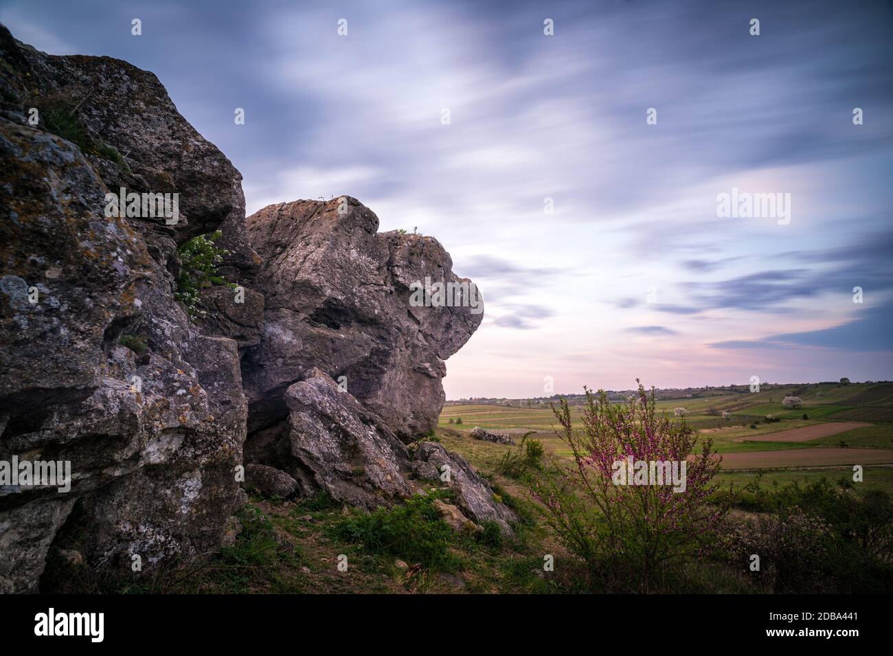 Landscape with boulder at sunrise with blured clouds Stock Photo