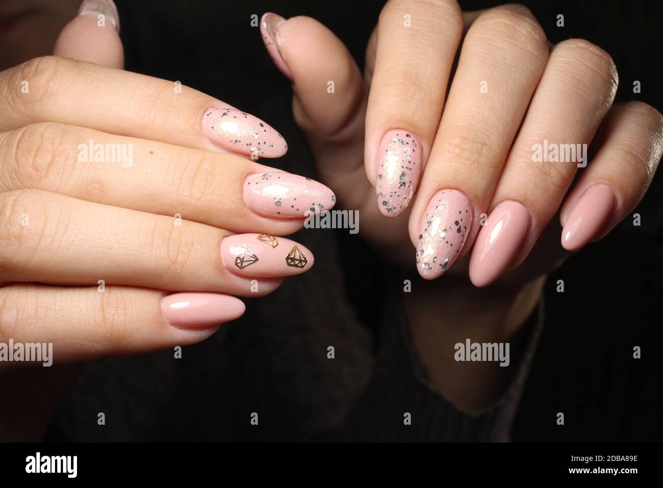 beautiful beige manicure of nails on the background of a fashionable  texture Stock Photo - Alamy