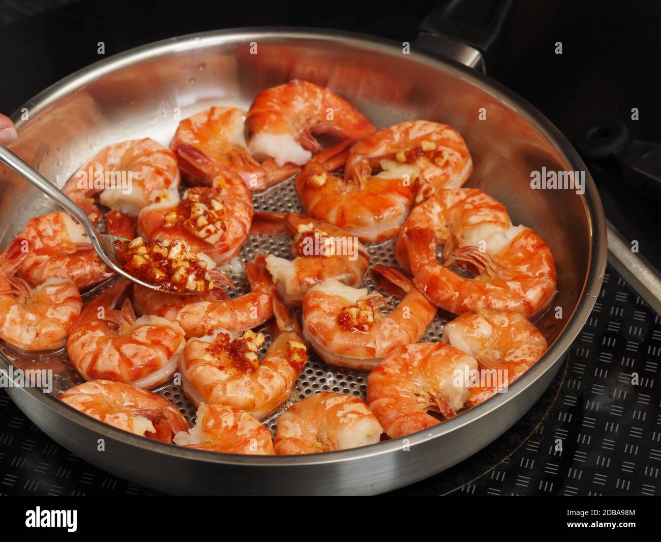 Frying organic black tiger prawns in a steel pan Stock Photo Alamy