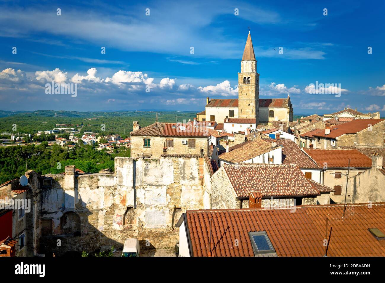 Old stone town of Buje tower and rooftops view, town in green landscape