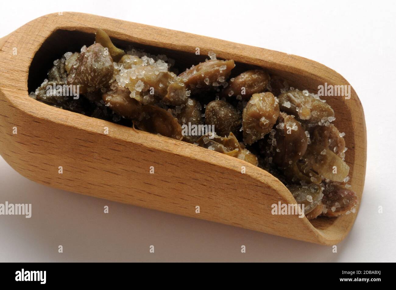 Capers under salt in the scoop Stock Photo Alamy