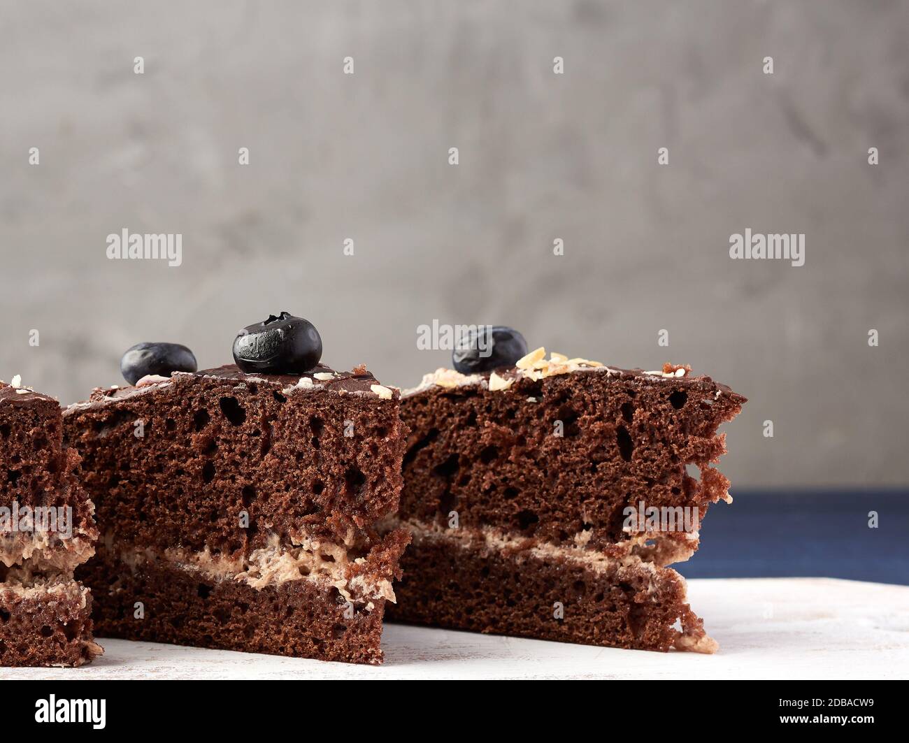 triangular pieces of chocolate biscuit cake with butter cream on a ...