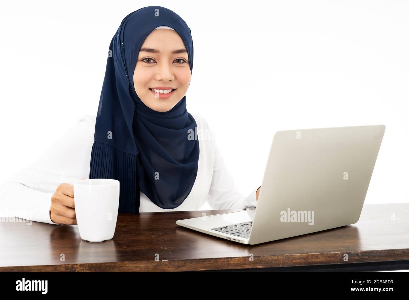 Asian young adult woman wearing hijab Working from home using laptop ...
