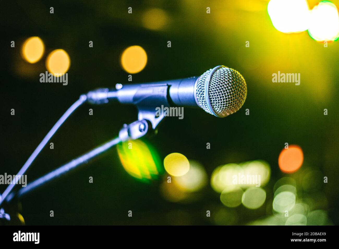 singer's vocal microphone stands on stage during a concert with multi