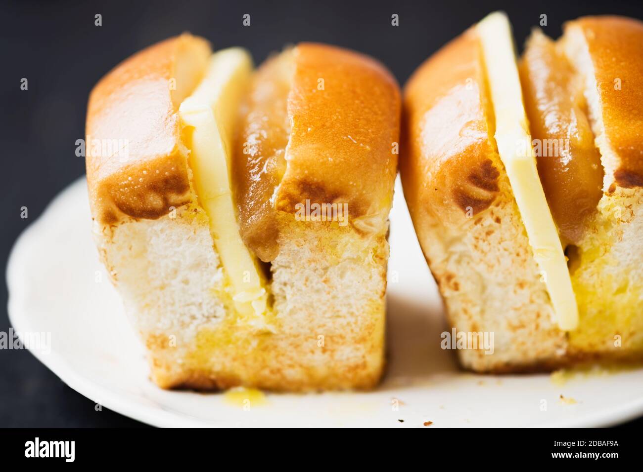 close up of rustic singapore malaysian kaya egg jam and butter bun