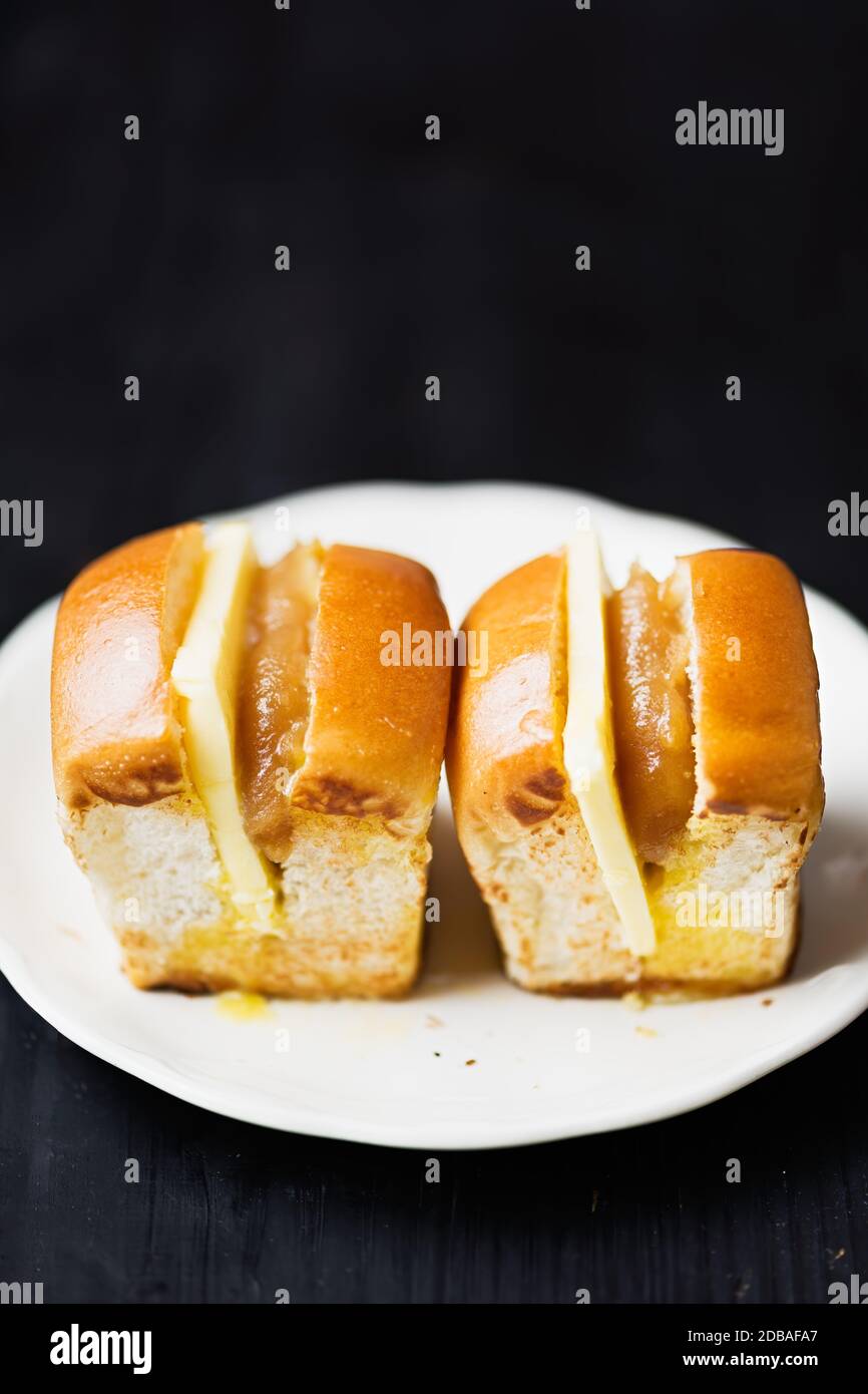 close up of rustic singapore malaysian kaya egg jam and butter bun