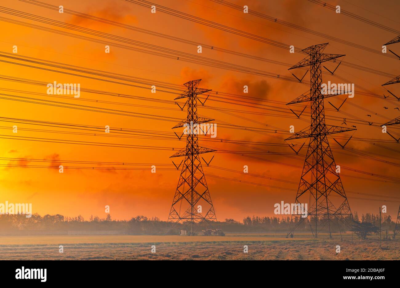 High voltage electric pylon and electrical wire with sunset sky ...
