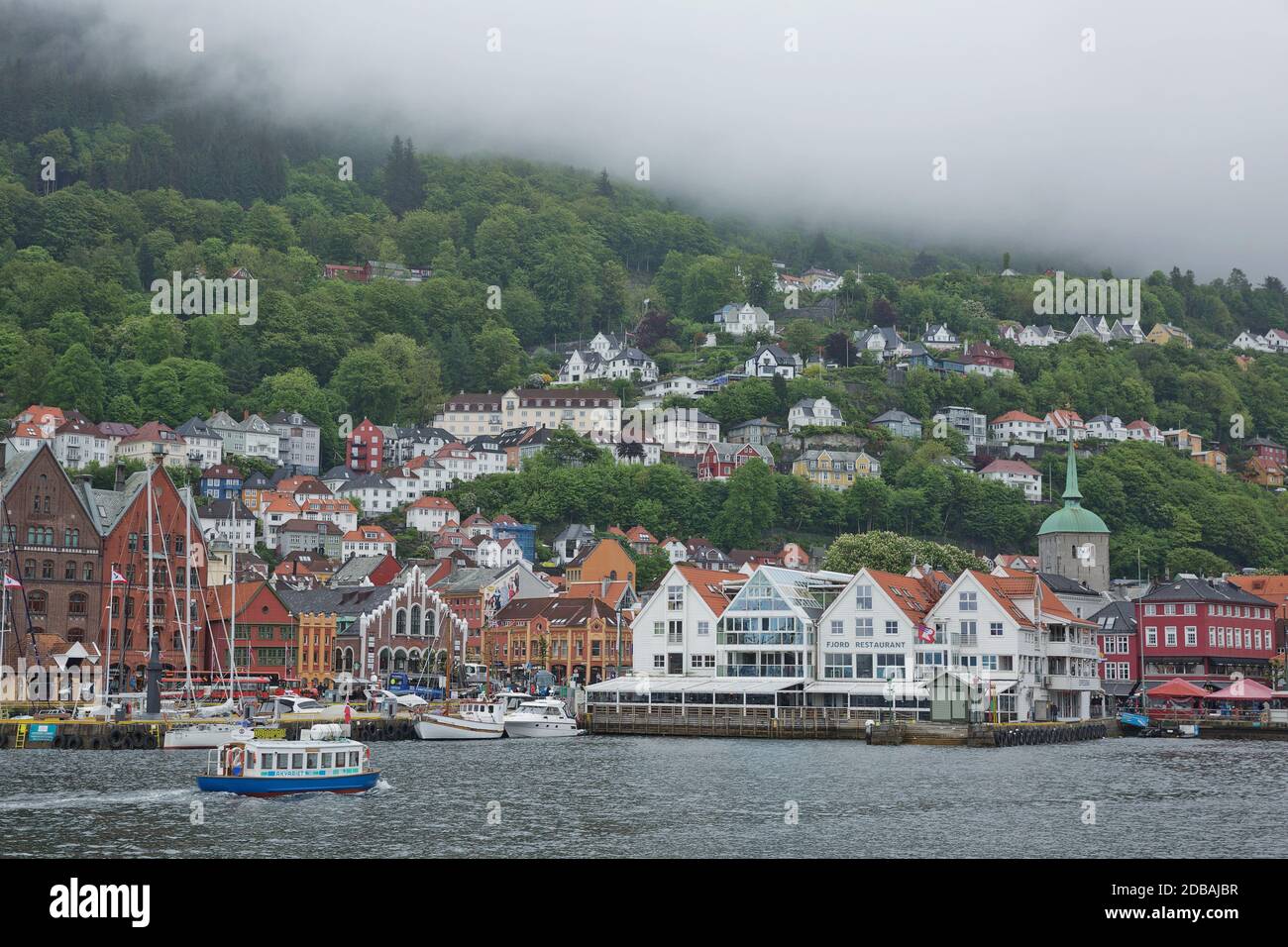 BERGEN, NORWAY - MAY 31, 2017: Old hansaetic wooden houses built in row at wharf of Bergen fjord are UNESCO World Heritage site and very popular for t Stock Photo