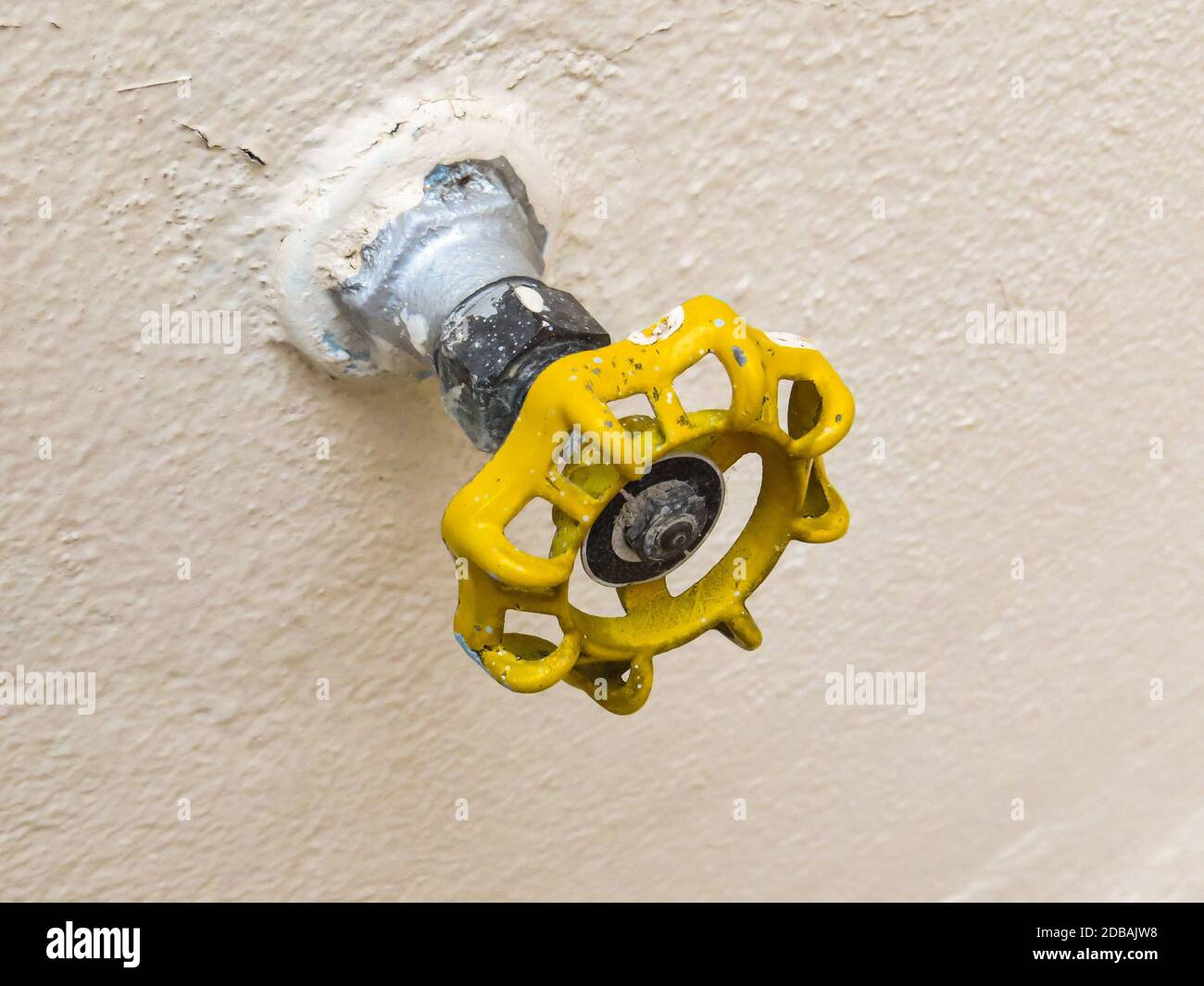 Top view of yellow tap isolated on soft backlight. Hydraulic valve