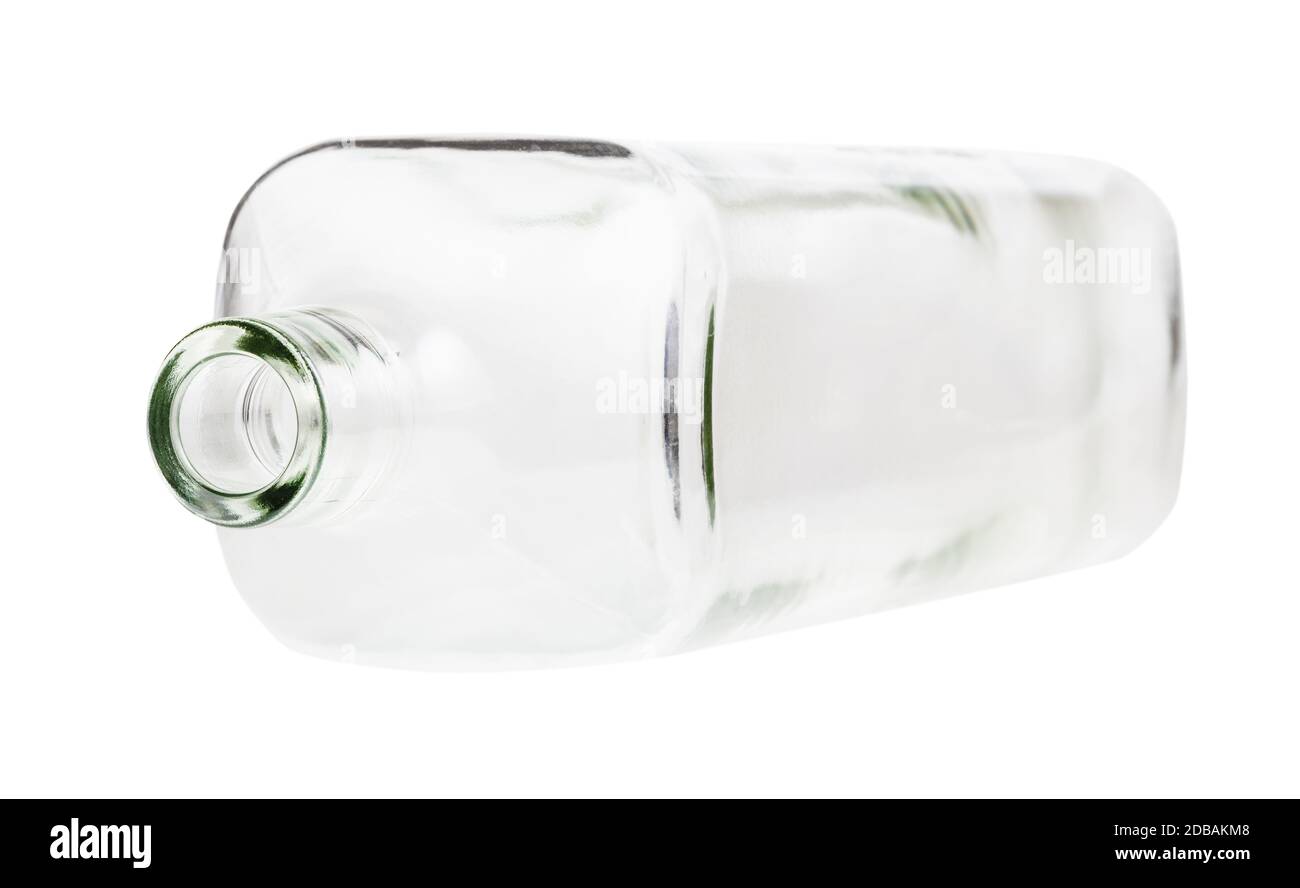 overturned empty clear whiskey bottle isolated on white background Stock Photo