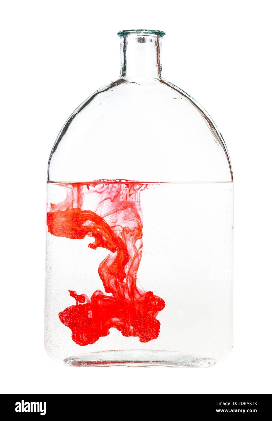 red ink dissolves in water in bottle isolated on white background Stock