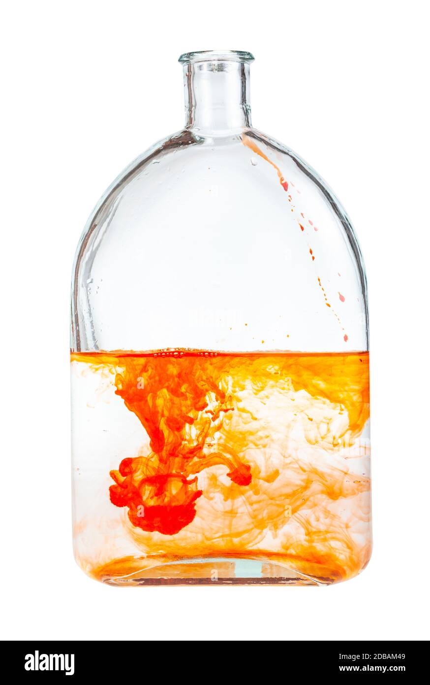 orange watercolour paint dissolves in water in glass flask isolated on