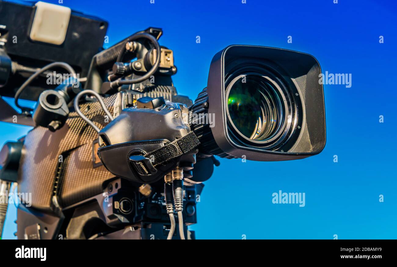 Professional tv camera on tripod recording social event on the street Stock Photo